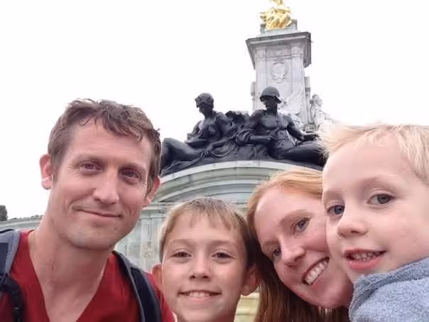 Kenneth, Denise and their two boys next to Buckingham Palace, London England.