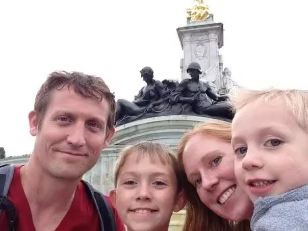 Kenneth, Denise and their two boys next to Buckingham Palace, London England.